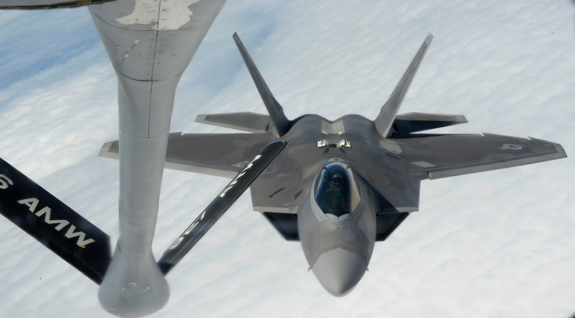 A KC-135 Stratotanker passes fuel through the boom to an F-22 Raptor during the First Term Airman Class incentive flight July 18, 2016. Nearly all internal fuel can be pumped through the boom, the KC-135's primary fuel transfer method. One crewmember, known as the boom operator, is stationed in the rear of the plane and controls the boom during in-flight air refueling. (U.S. Air Force photo by Airman 1st class Rito Smith)