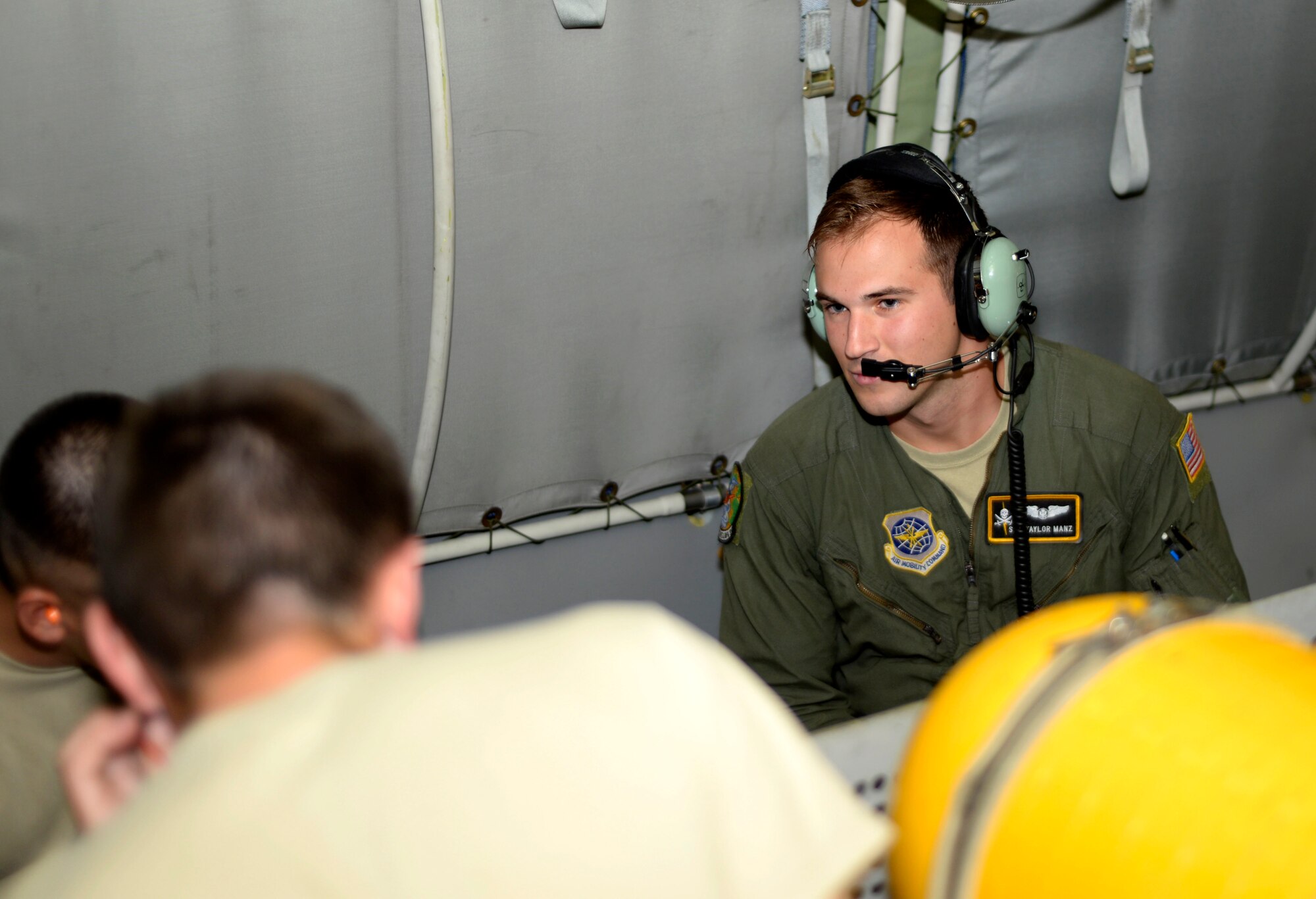 Senior Airman Taylor Manz, a Boom Operator assigned to the 91st Air Refueling Squadron explains some of the tasks expected of him as a boom operator July 18, 2016. Some of the tasks expected of a boom operator include in-flight refueling, supervising cargo and passenger loading and off-loading operations, and performing jumpmaster duties when necessary. (U.S. Air Force photo by Airman 1st class Rito Smith)