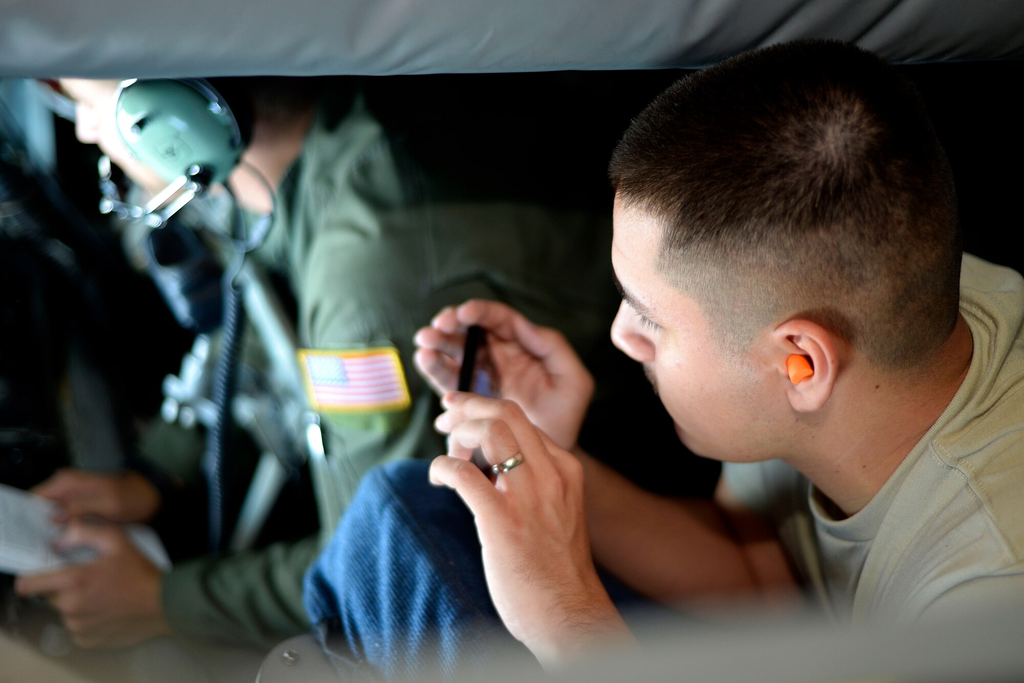 Airman 1st Class Ysaak Hemenway, a new Airman assigned to the 6th Operations Support Squadron takes a picture as the boom operator refuels an F-22 Raptor July 18, 2016. Boom operators provide a very important tactical advantage when aircraft need refueling midflight by allowing them to stay in the air and complete their mission. (U.S. Air Force photo by Airman 1st class Rito Smith)