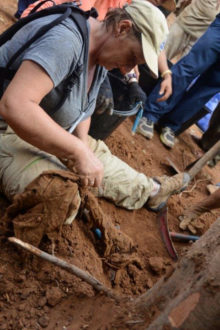 Dr. Penny Minturn, Defense POW/MIA Accounting Agency (DPAA) anthropologist, studies an article of clothing found during excavation in search of missing service members from the Vietnam War, November 19, 2015, in the Vietnamese National Forest. DPAA’s mission is to provide the fullest possible accounting for our missing personnel to their families and the nation. 