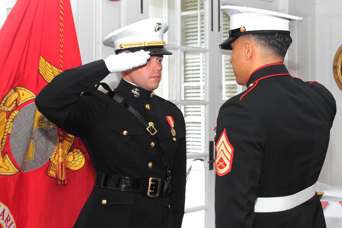 Marine Corps 2nd Lt. Reagan Reynolds returns a salute for the first time as a commissioned officer to Marine Corps Staff Sgt. Ibrahim Attya in the University Club, at the University of Alabama in Tuscaloosa, Ala.,, July 15, 2016. Reynolds joined the Platoon Leaders Class his freshman year of college after learning about the Marine Corps officer program. Reagan is a native of Nacogdoches, Texas. Attya is the officer selection assistant of Tuscaloosa, Alabama, and a native of Boston, Mass.. Marine Corps photo by Cpl. Diamond N. Peden