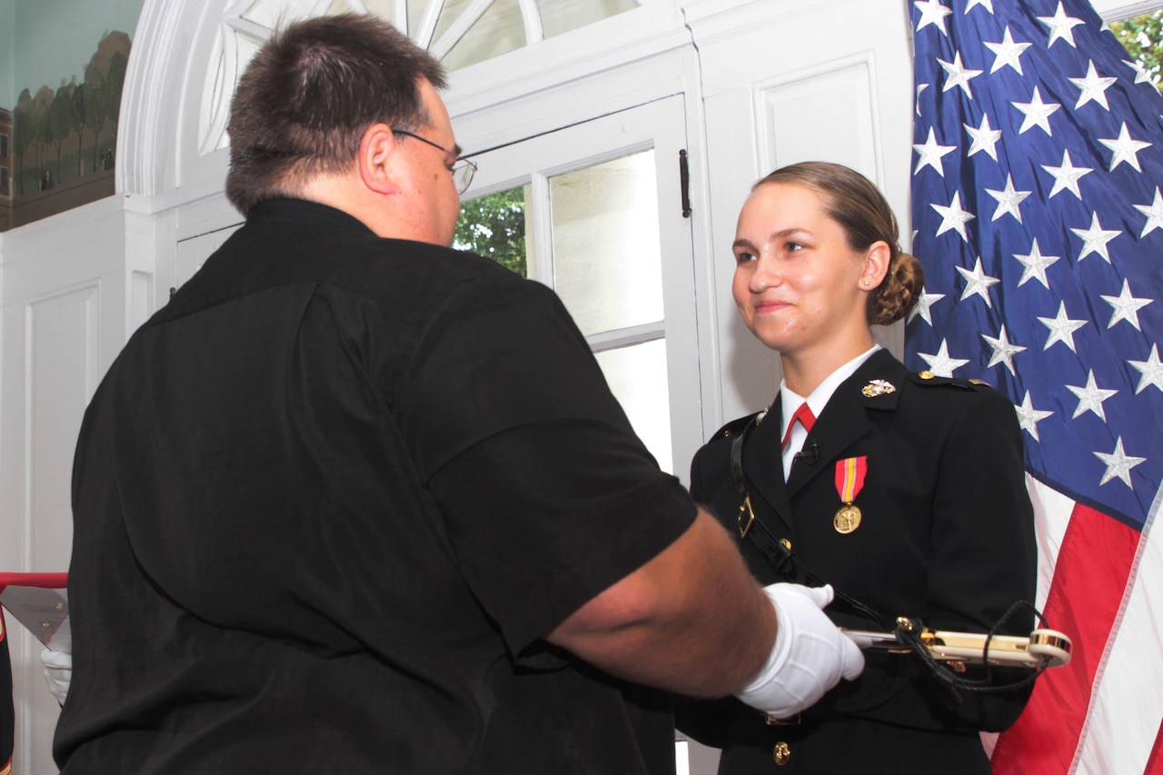 Marine Corps 2nd Lt. Reagan Reynolds returns a salute for the first time as a commissioned officer to Marine Corps Staff Sgt. Ibrahim Attya in the University Club, at the University of Alabama in Tuscaloosa, Ala., July 15, 2016. Reynolds joined the Platoon Leaders Class his freshman year of college after learning about the Marine Corps officer program. Reagan is a native of Nacogdoches, Texas. Attya is the officer selection assistant of Tuscaloosa, Alabama, and a native of Boston, Mass. Marine Corps photo by Cpl. Diamond N. Peden