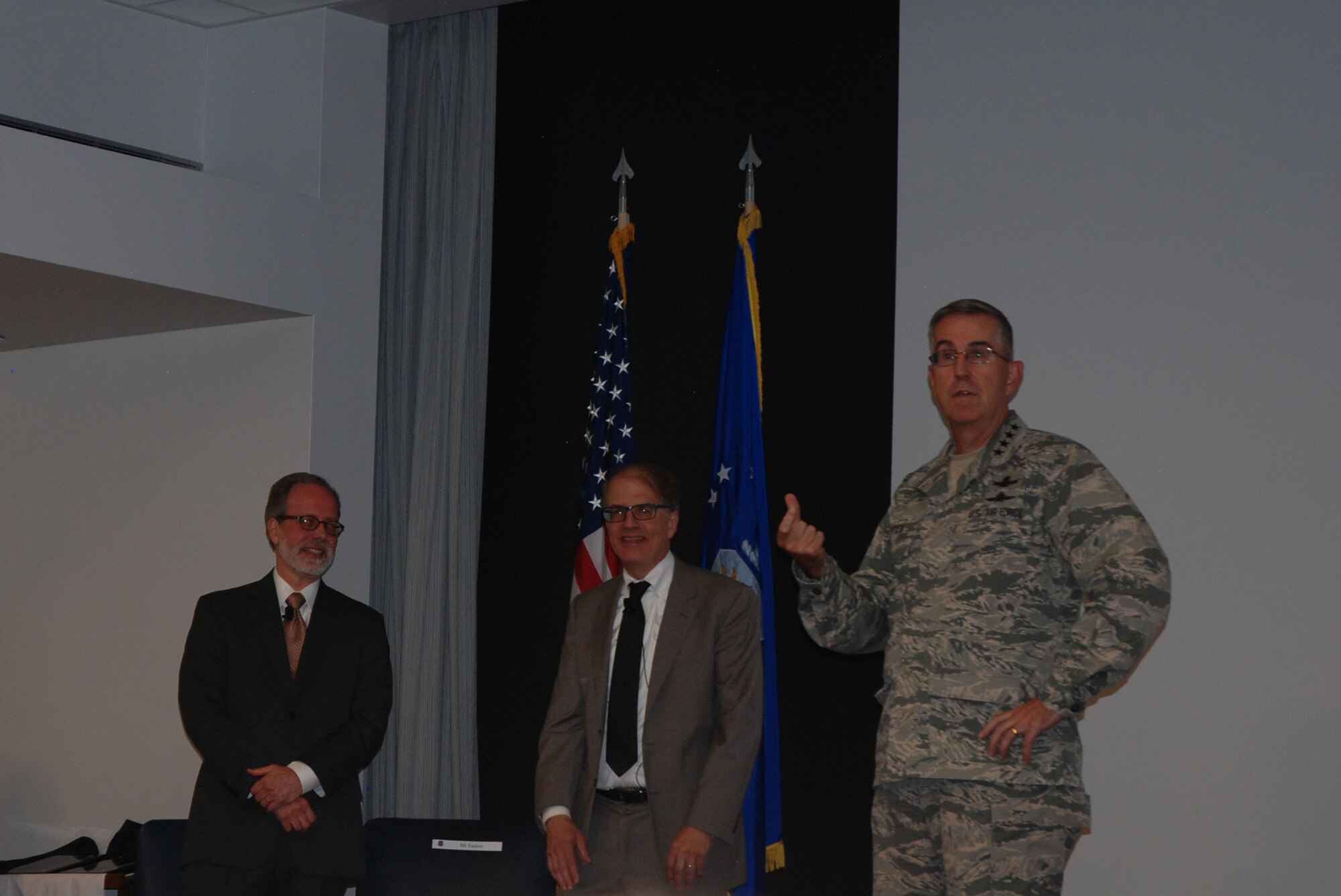 PETERSON AIR FORCE BASE, Colo. – Gen. John Hyten, Air Force Space Command commander, introduces Eric Frazier, left, and Richard Easton, authors of “GPS Declassified: From Smart Bombs to Smartphones.” The book was part of the National Security Space Institution’s reading list and the authors made a presentation to members of Team Pete on July 21, 2016 as part of the NSSI speaker series. (U.S. Air Force photo by Dave Smith)