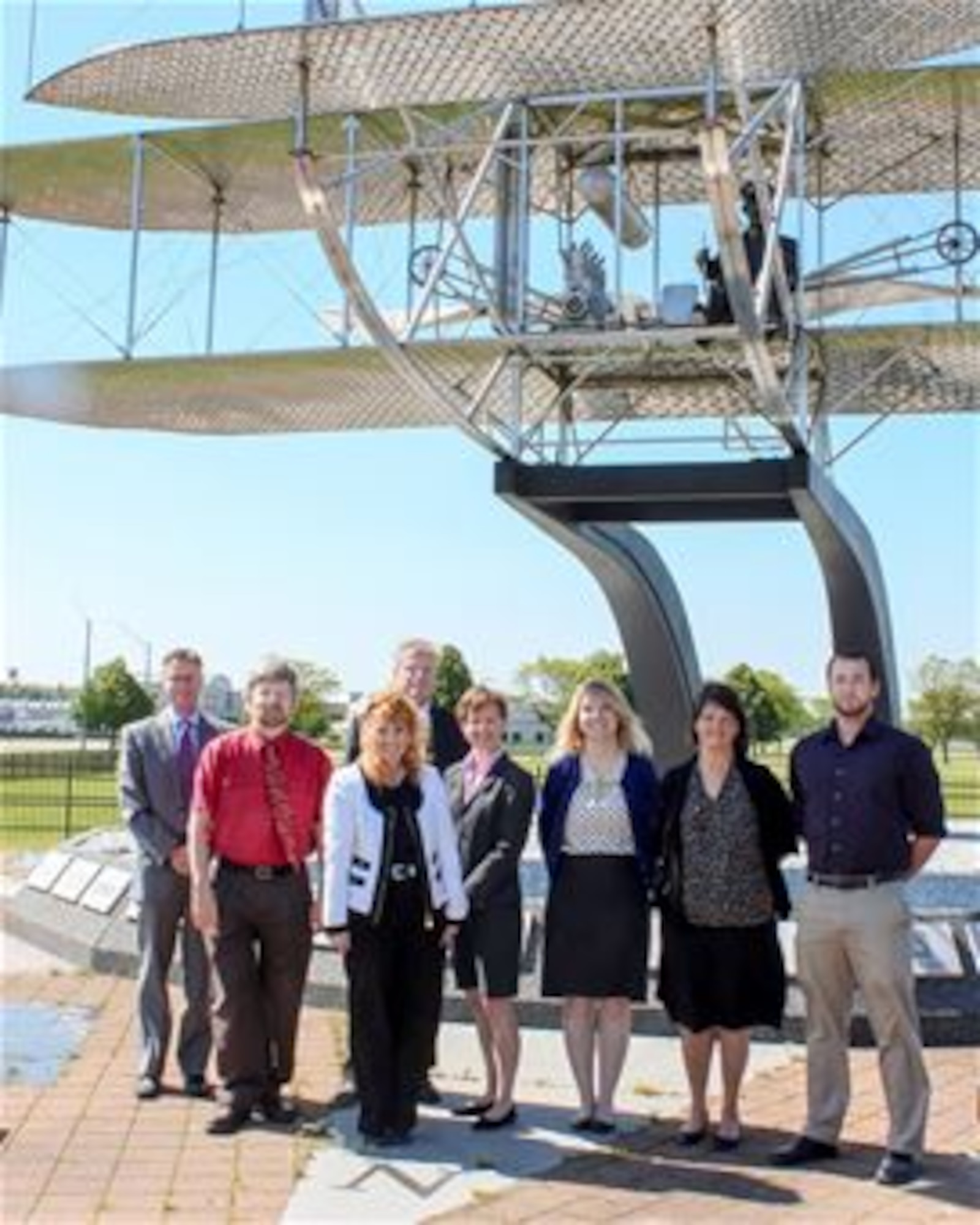 The Non-DoD Military Aircraft Office at Wright-Patterson Air Force Base gather at the Wright Brothers memorial. The office is the Air Force's latest innovative concept for supporting airworthiness assessments. Members of the office include (from left to right) Rob Lymangrover, Keith Quinn, Jane White, Bob FitzHarris, Victoria Russell, Jennifer Miller, Joy Williams, Alex Kreider Not pictured: Ronnie Rawls and Ruby Schrader. (Contributed photo) 