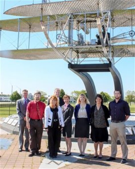 The Non-DoD Military Aircraft Office at Wright-Patterson Air Force Base gather at the Wright Brothers memorial. The office is the Air Force's latest innovative concept for supporting airworthiness assessments. Members of the office include (from left to right) Rob Lymangrover, Keith Quinn, Jane White, Bob FitzHarris, Victoria Russell, Jennifer Miller, Joy Williams, Alex Kreider Not pictured: Ronnie Rawls and Ruby Schrader. (Contributed photo) 