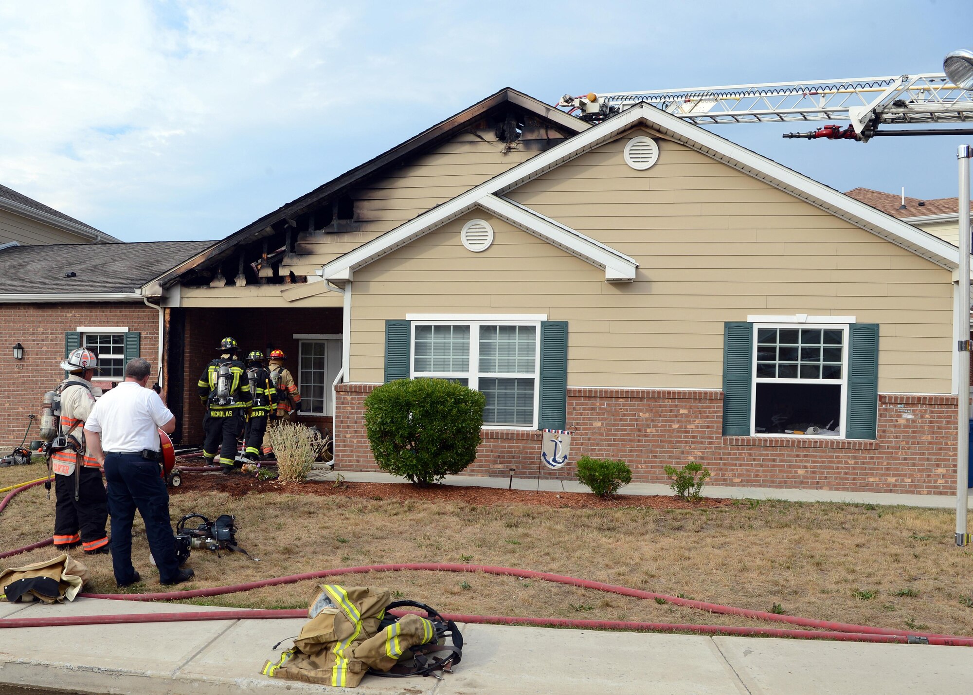 The Hanscom Fire Department, as well as firefighters from surrounding communities, respond to a house fire on Mayflower Road in Hanscom Family Housing July 25. There were no injuries during the fire.  (U.S. Air Force photo by Jerry Saslav)