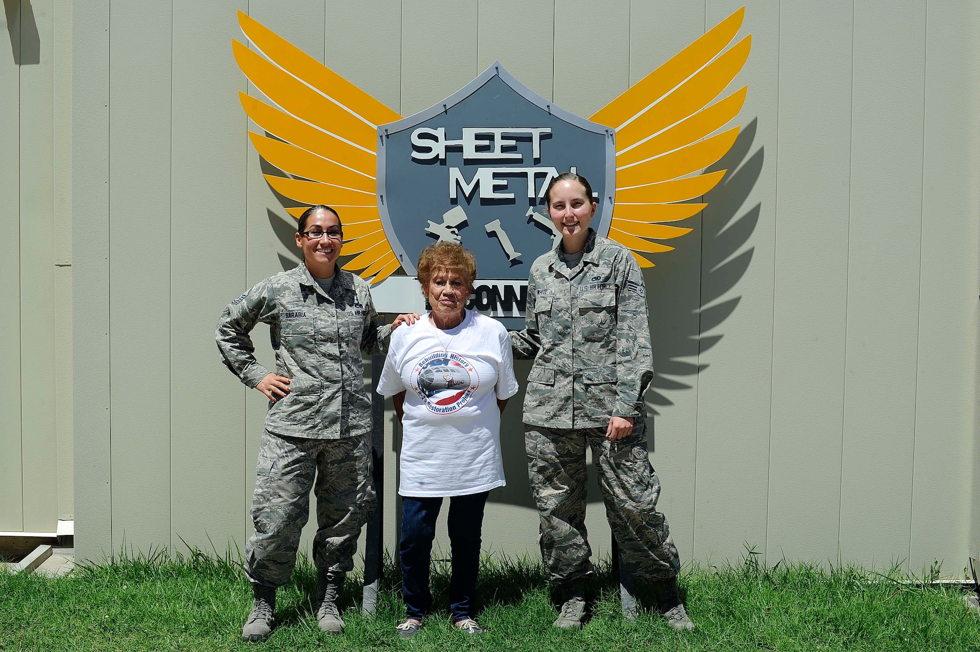 Master Sgt. Elizabeth Sarabia, 931st Maintenance Squadron aircraft structural maintenance section chief, left, and Senior Airman Ciarra White, 22nd Maintenance Squadron ASM journeyman, right, pose with Connie Palacioz, a riveter during World War II, July 20, 2016, at McConnell Air Force Base, Kan. Palacioz recently visited the base sheet metal shop where she received a tour and spoke with Airmen. (U.S. Air Force photo/Airman 1st Class Jenna K. Caldwell)