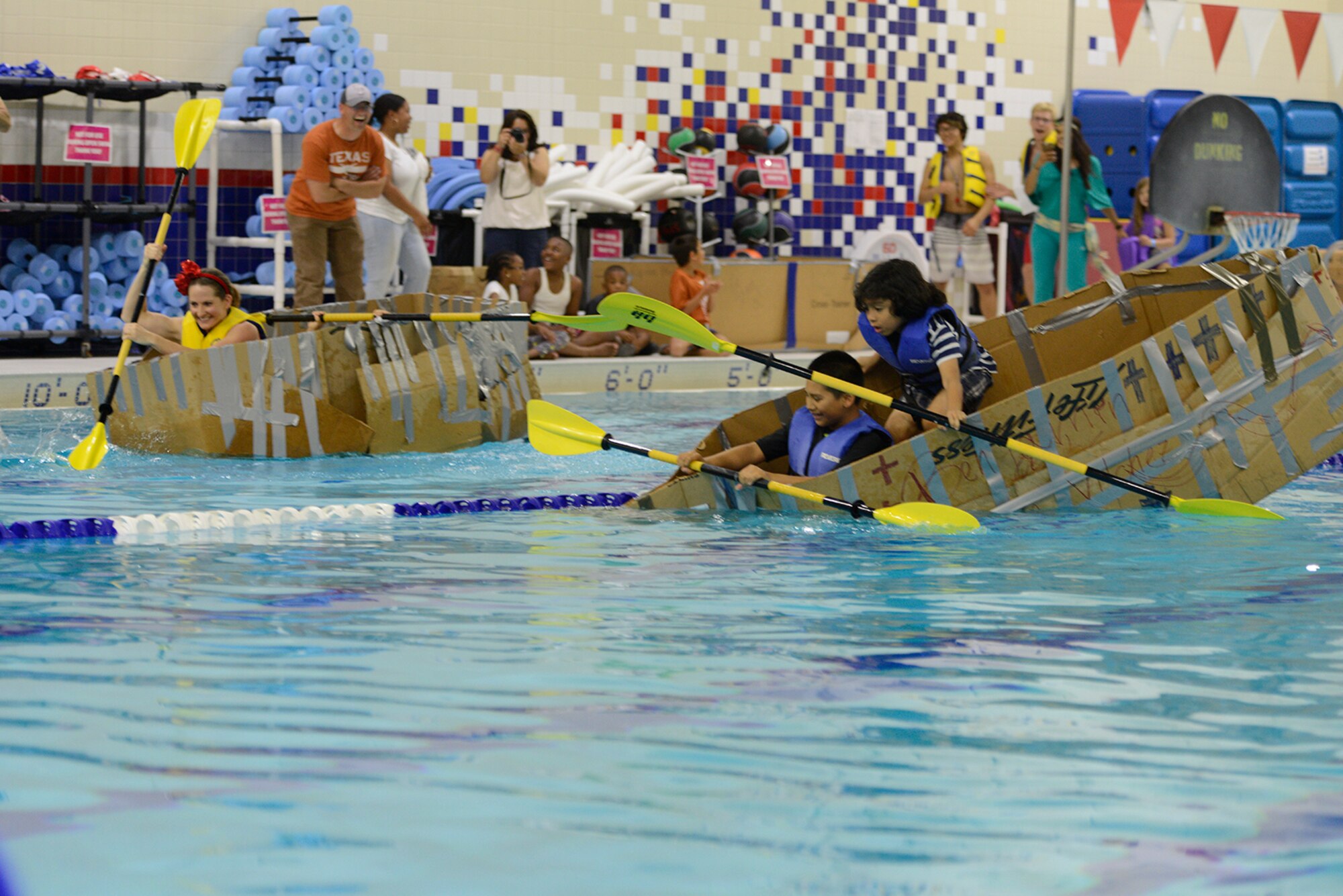 Jaden Terre, 9, and Benjamin Vilchez, 7, brace for the inevitable capsizing of their boat at the Build-A-Boat competition at Buckner Physical Fitness Center at Joint Base Elmendorf-Richardson, Alaska, July 23, 2016. Fifteen teams participated in the competition. (U.S. Air Force photo by Airman 1st Class Javier Alvarez)