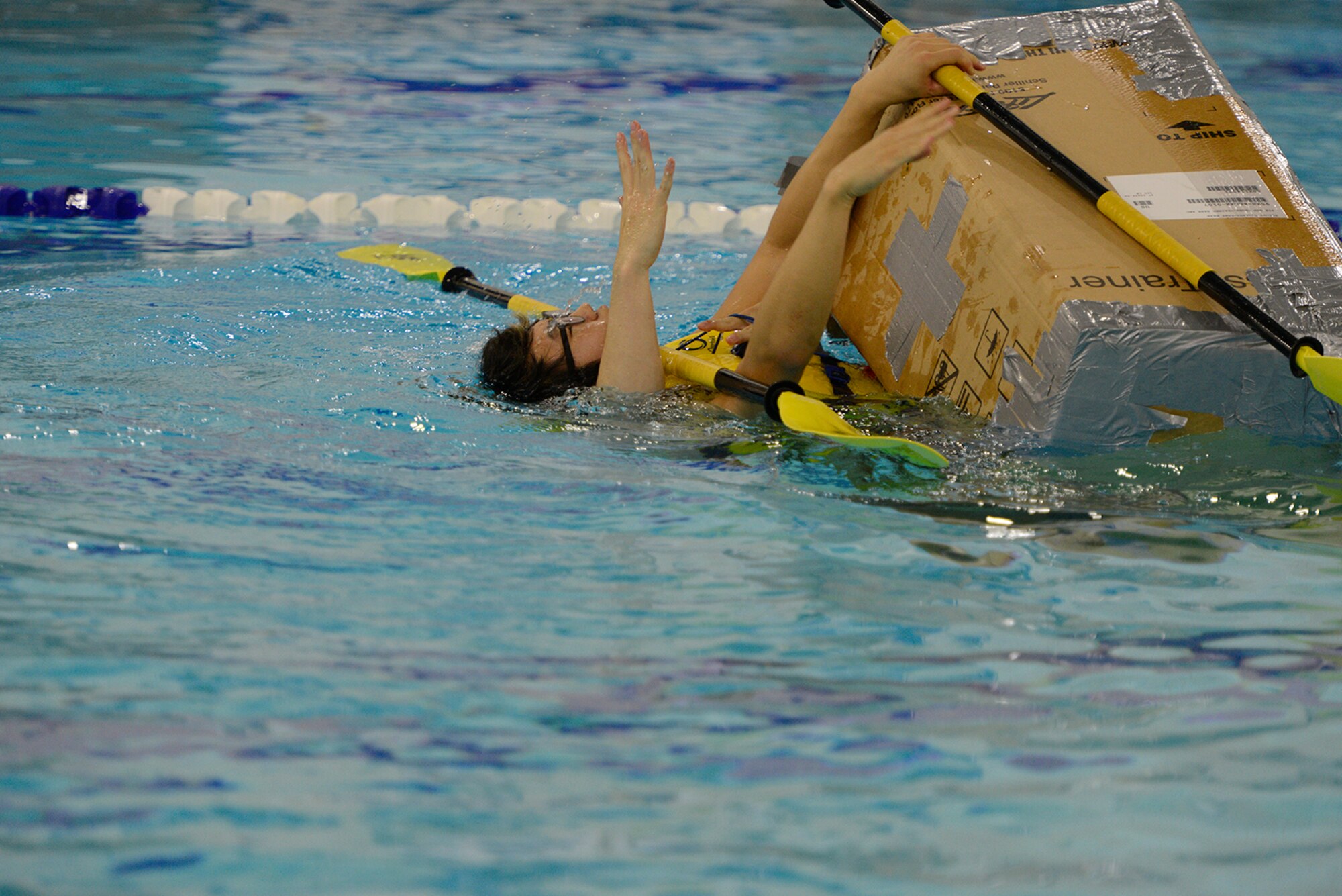 A Joint Base Elmendorf-Richardson captain and first mate make final attempt to prevent their boat from capsizing at Buckner Physical Fitness Center at JBER, Alaska, July 23, 2016.  Boats were raced by teams of two for prizes. (U.S. Air Force photo by Airman 1st Class Javier Alvarez)