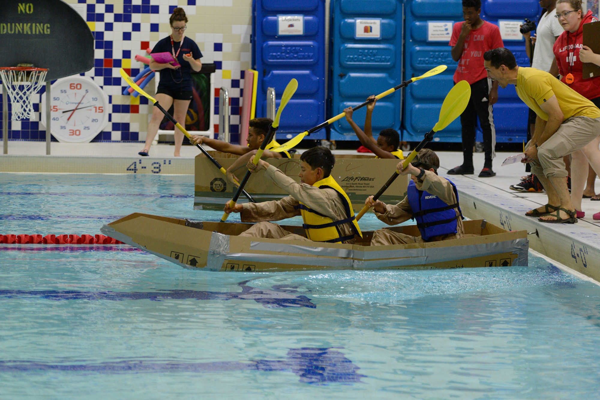 John Limon, Buckner Physical Fitness Center director, announces the start of a boat race at Buckner PFC at Joint Base Elmendorf-Richardson, Alaska, July 23, 2016. Cardboard vessels were raced 50 yards at the Buckner gym pool. (U.S. Air Force photo by Airman 1st Class Javier Alvarez)