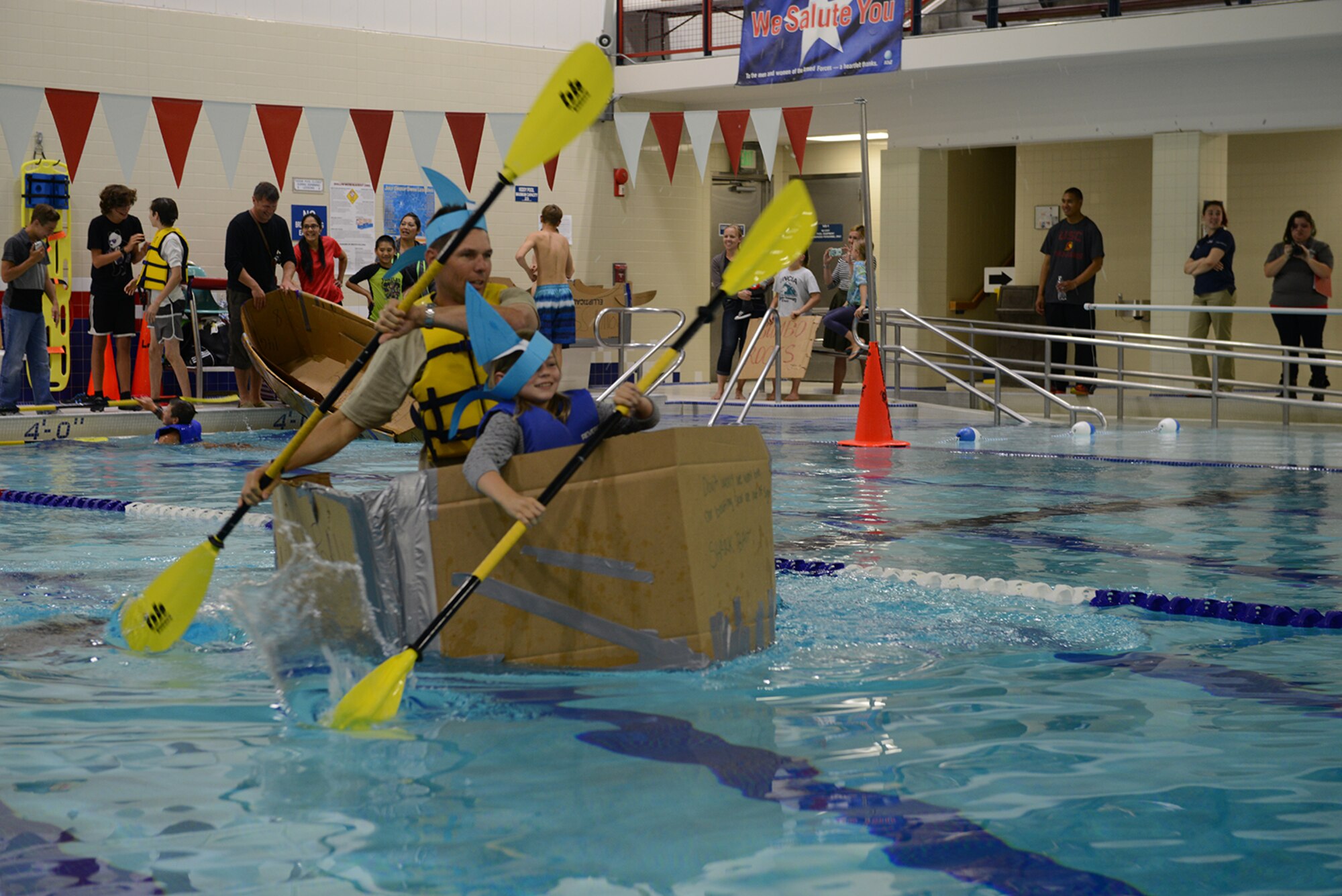 Harlie Bodine, 611th Air Operations Center commander, and Annalise Bodine, 9, synchronize their paddle strokes at the build a boat competition at Buckner Physical Fitness Center at Joint Base Elmendorf-Richardson, Alaska, July 23, 2016. This was the second Build-A-Boat competition hosted at JBER. (U.S. Air Force photo by Airman 1st Class Javier Alvarez)