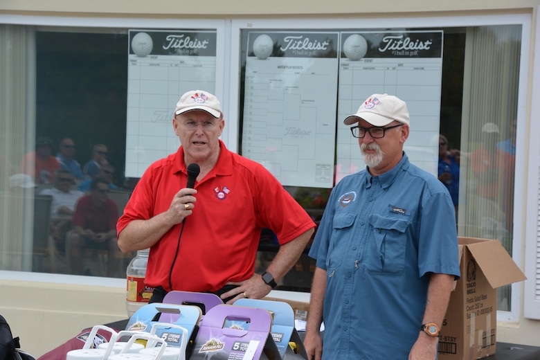 Royal Canadian Air Forces LCol (Ret) Larry Weir (left) joins AMIKids Panama City Marine Institute Executive Director Ron Boyce for some remarks prior to the prize portion of the 2016 Canadian American Golf Tournament. The AMIkids Panama City Marine Institute was the designated recipient of the charity funds raised during the tournament which totaled $3200. (Air Force Photo/Maj. Katrina Andrews)