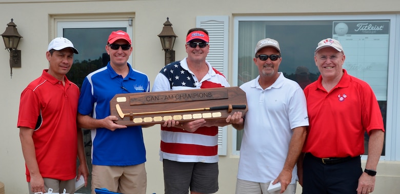 Royal Canadian Air Forces LCol (Ret) Larry Weir, (right) flanks the Canadian American Golf Tournament 2016 winning-team members as they proudly display their trophy. Team members from left: David Clemens, Continental U.S. Aerospace Defense Region – 1st Air Force (Air Forces Northern) Financial Management Office; Maj. Troy Lindig, Operations Directorate; Col. Tony Burris, Director, Communications and Cyber Forces Directorate; and David Kostic, Chief, Financial Management Office. (Air Force Photo/Maj. Katrina Andrews)