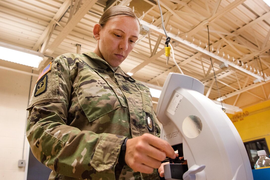 Army Sgt. 1st Class Autumn Rodriguez inspects finished lenses before providing them to a patient in Cortland, N.Y., July 18, 2016, during the Greater Chenango Cares Innovative Readiness Training. Rodriguez is the director of training at the Tri-Service Optician School assigned to the Naval Ophthalmic Support and Training Activity. Air National Guard photo by Senior Master Sgt. Elizabeth Gilbert