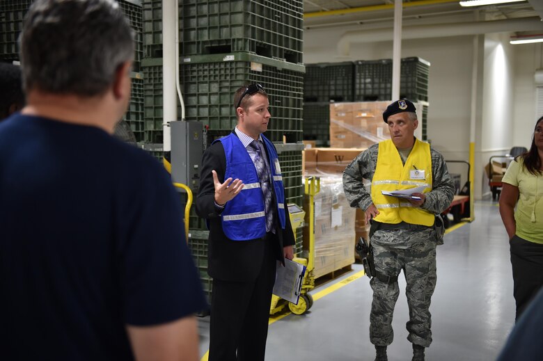 Robert Brown, special agent with the Air Force Office of Special Investigations, debriefs building occupants following an active shooter training exercise here, July 26, 2016. Brown explained what would happen in the aftermath of an active shooter event. The base-wide exercise involved an active shooter opening fire in the supply building using blank rounds shot from an M-4 training rifle. All base buildings were locked down and some work centers were evacuated while Wing Inspection Team members evaluated. The scenario was designed to test responses from building managers and occupants and installation security forces. (U.S. Air Force photo/Eric White)