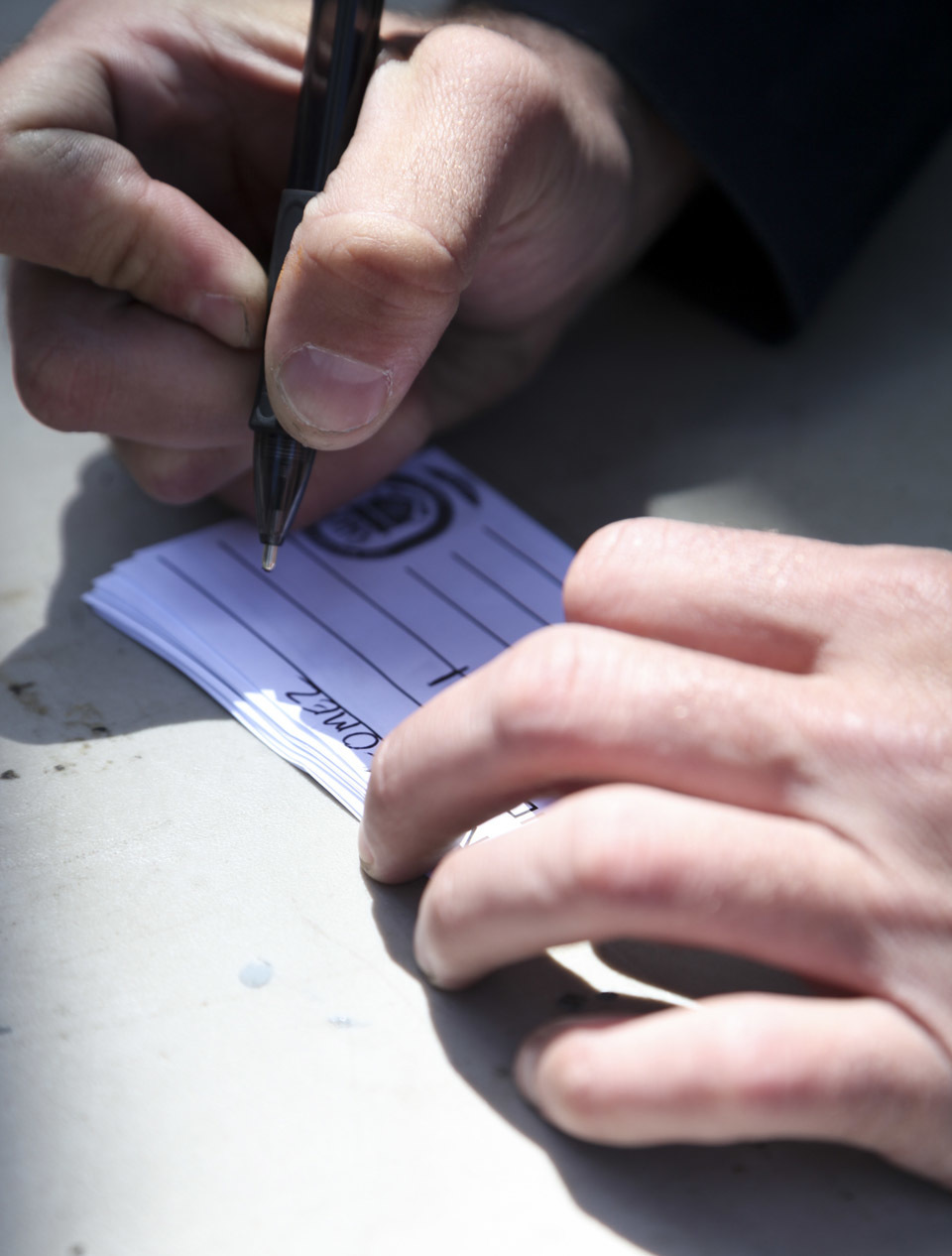 U.S. Navy Chief Petty Officer Josh Amaral, master at arms, creates security badges for a simulated evacuee during an evacuation control center drill aboard the USS Whidbey Island (LSD 41), April 13, 2016. The Sailors conducted the exercise to simulate and validate procedures that would be used during an evacuation. 