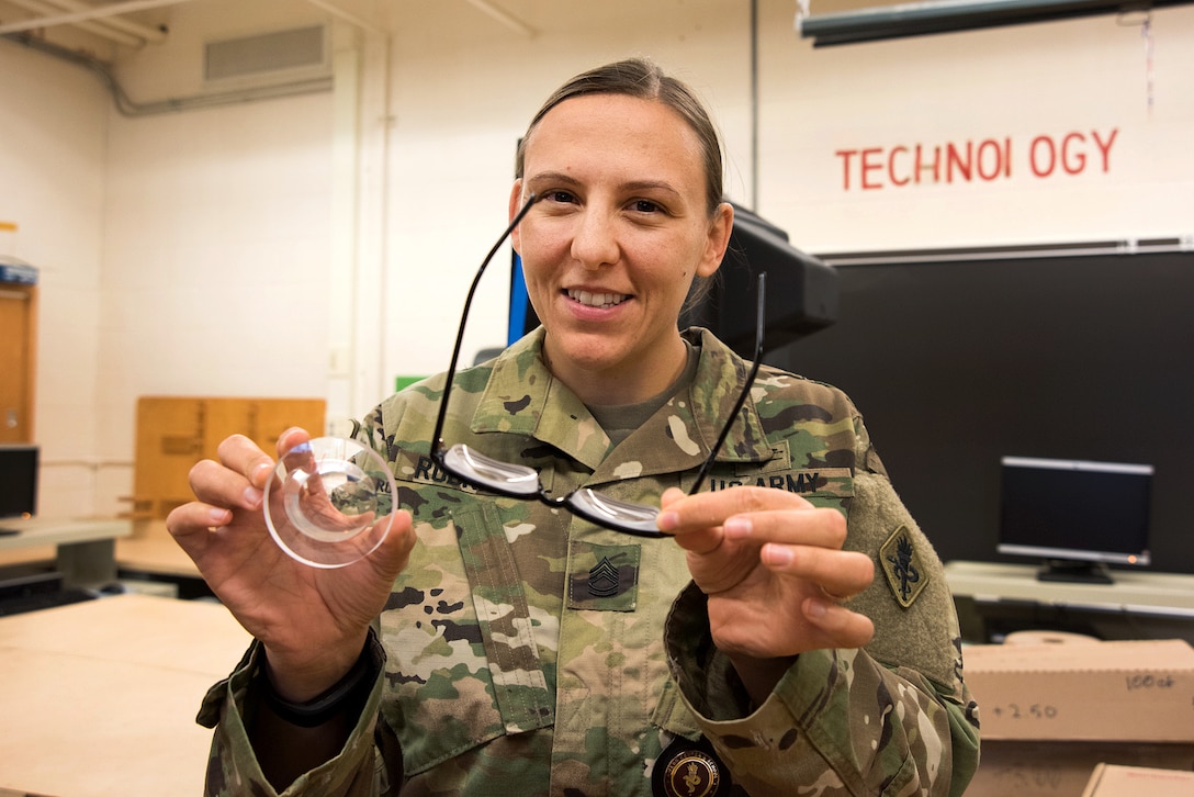 Army Sgt. 1st Class Autumn Rodriguez displays a lens as well as a pair of glasses for a patient in Cortland, N.Y., July 18, 2016, during the Greater Chenango Cares Innovative Readiness Training. Air National Guard photo by Senior Master Sgt. Elizabeth Gilbert