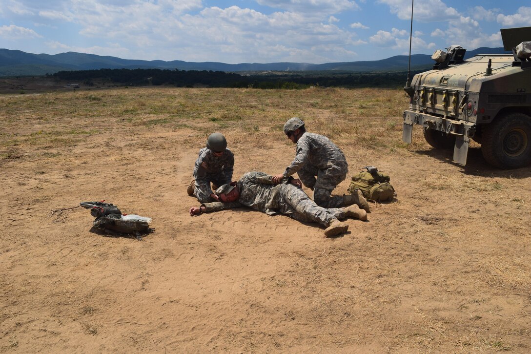 Cpl. Alexandra Jordan, a medic with the 766th Engineer Company (Horizontal), 841st Engineer Battalion, U.S. Army Reserve, and Spc. Jorge A. Arcineigas, a medic with the Headquarters and Headquarters Company, 841st Eng. Bn., respond to a simulated casualty during a casualty evacuation drill at Novo Selo Training Area, Bulgaria as part of Operation Resolute Castle 16, July 23, 2016. The drill was designed to validate procedures and protocol for both the battalion staff and personnel in the field. (U.S. Army photo by Capt. Jose F. Lopez Jr., 841st Eng. Bn., United States Army Reserve)