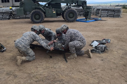 Medical soldiers from the 841st Engineer Battalion and the 268th Military Police Company, 194th Engineer Brigade, Tennessee Army National Guard, prepare to lift a simulated casualty onto a stretcher. These types of injuries require minimal movement of the casualty and enhanced care. The soldiers executed this battle drill in order to ensure familiarization and efficiency in coordinating between units. This training was held at Novo Selo Training Area, Bulgaria as part of Operation Resolute Castle 16, July 23, 2016. (U.S. Army photo by Capt. Jose F. Lopez Jr., 841st Eng. Bn., United States Army Reserve)