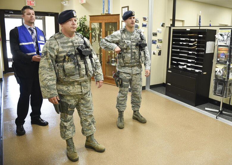 Robert Brown, special agent with the Air Force Office of Special Investigations, observes as 910th Security Forces fire team members Staff Sgt. Marcus Weisbarth and Tech. Sgt. Richard Lape are debriefed after neutralizing an active shooter in a training exercise here, July 26, 2016. The base-wide exercise involved an active shooter opening fire in the supply building using blank rounds shot from an M-4 training rifle. All base buildings were locked down and some work centers were evacuated while Wing Inspection Team members evaluated. The scenario was designed to test responses from building managers and occupants and installation security forces. (U.S. Air Force photo/Eric White)