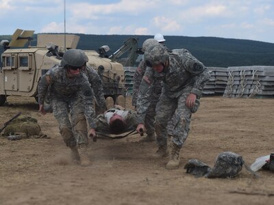 Cpl. Alexandra Jordan, a medic with the 766th Engineer Company (Horizontal), 841st Engineer Battalion, U.S. Army Reserve, and Pfc. Steven Armes, a medic with the 268th Military Police Company, 194th Engineer Brigade, Tennessee Army National Guard, lift a simulated casualty during a casualty evacuation drill has they prepare to move him to the Troop Medical Clinic at Novo Selo Training Area, Bulgaria as part of Operation Resolute Castle 16, July 23, 2016. The drill was designed to validate procedures and protocol for both the battalion staff and personnel in the field as well as exercise communication and cooperation between the two units. (U.S. Army photo by Capt. Jose F. Lopez Jr., 841st Eng. Bn., United States Army Reserve)