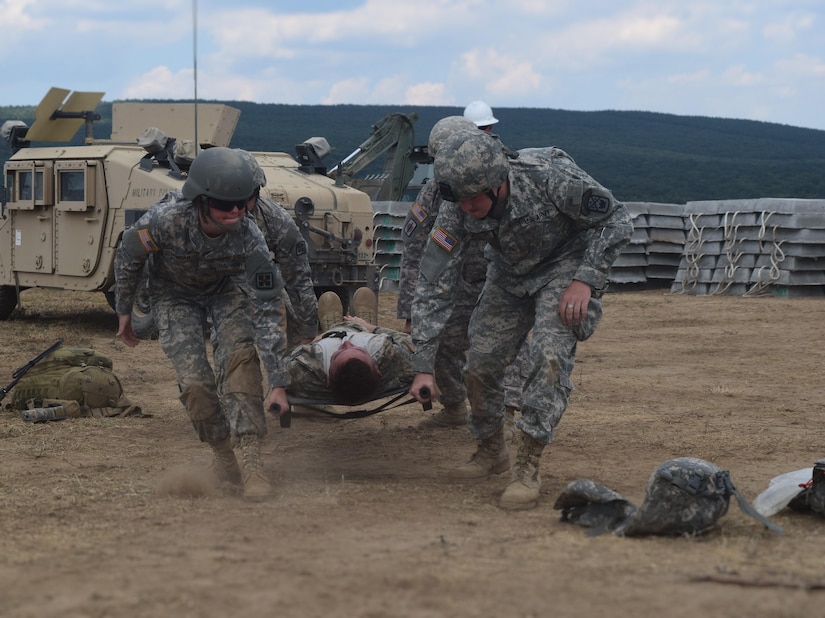 Cpl. Alexandra Jordan, a medic with the 766th Engineer Company (Horizontal), 841st Engineer Battalion, U.S. Army Reserve, and Pfc. Steven Armes, a medic with the 268th Military Police Company, 194th Engineer Brigade, Tennessee Army National Guard, lift a simulated casualty during a casualty evacuation drill has they prepare to move him to the Troop Medical Clinic at Novo Selo Training Area, Bulgaria as part of Operation Resolute Castle 16, July 23, 2016. The drill was designed to validate procedures and protocol for both the battalion staff and personnel in the field as well as exercise communication and cooperation between the two units. (U.S. Army photo by Capt. Jose F. Lopez Jr., 841st Eng. Bn., United States Army Reserve)