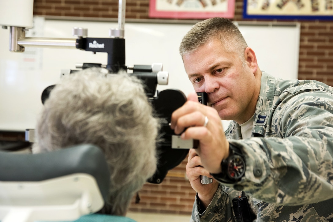 Air Force Capt. Brett Ringger examines a patient’s eyes during the Greater Chenango Cares Innovative Readiness Training in Cortland, N.Y., July 18, 2016. Ringger is an optometrist assigned to the Texas Air National Guard’s 136th Medical Group. Air National Guard photo by Senior Master Sgt. Elizabeth Gilbert