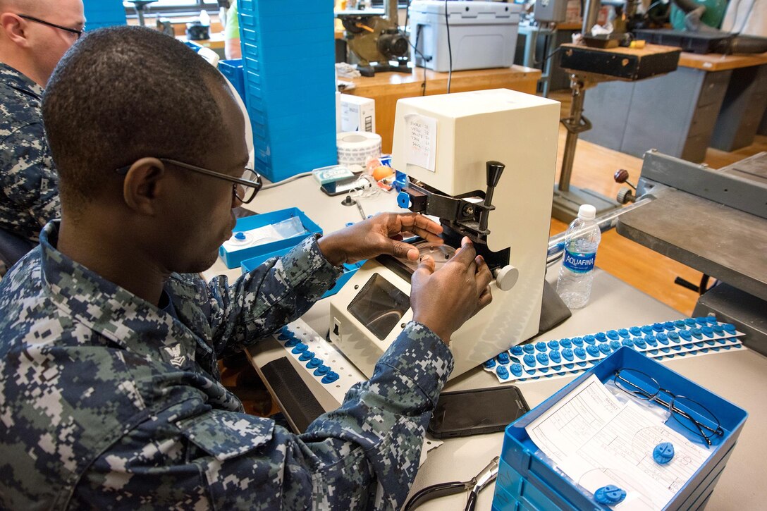 Navy Petty Officer 2nd Class Samuel Addo-Donkoh prepares lenses for a patient during the Greater Chenango Cares Innovative Readiness Training in Cortland, N.Y., July 18, 2016. Addo-Donkoh is a hospitalman assigned to the Naval Ophthalmic Support and Training Activity. Air National Guard photo by Senior Master Sgt. Elizabeth Gilbert