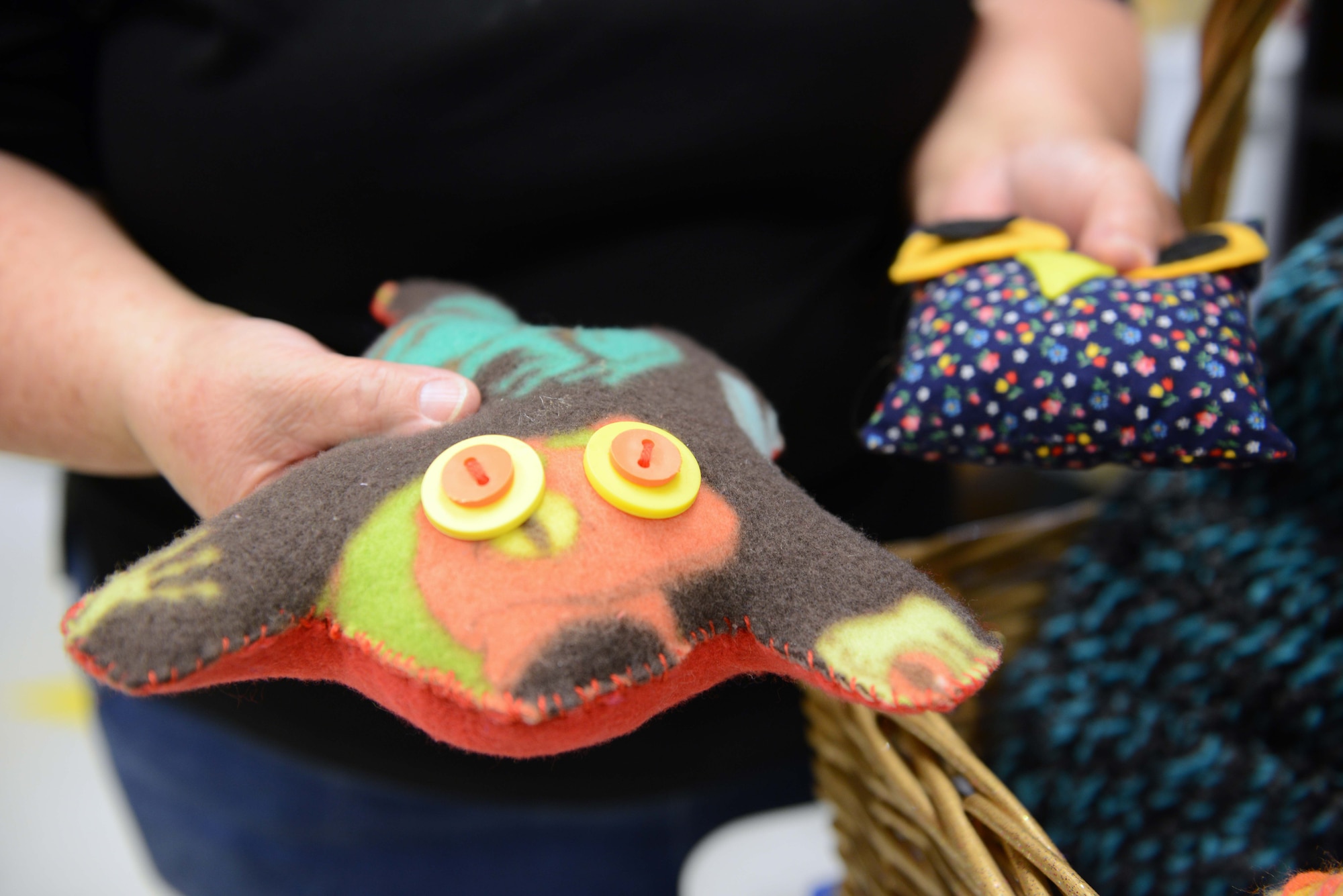 Kandis Kile, Two Rivers Youth Center recreation specialist, displays sewing camp creations at the Two Rivers Youth Center at Joint Base Elmendorf-Richardson, Alaska, July 21, 2016. In 2015, more than 300 pillow cases were donated to foster children, and both veterans and non-veterans at a Palmer senior center by youth center sewing aficionados, said Kandis Kile, Two Rivers Youth Center recreation specialist. (U.S. Air Force photo by Airman 1st Class Javier Alvarez)