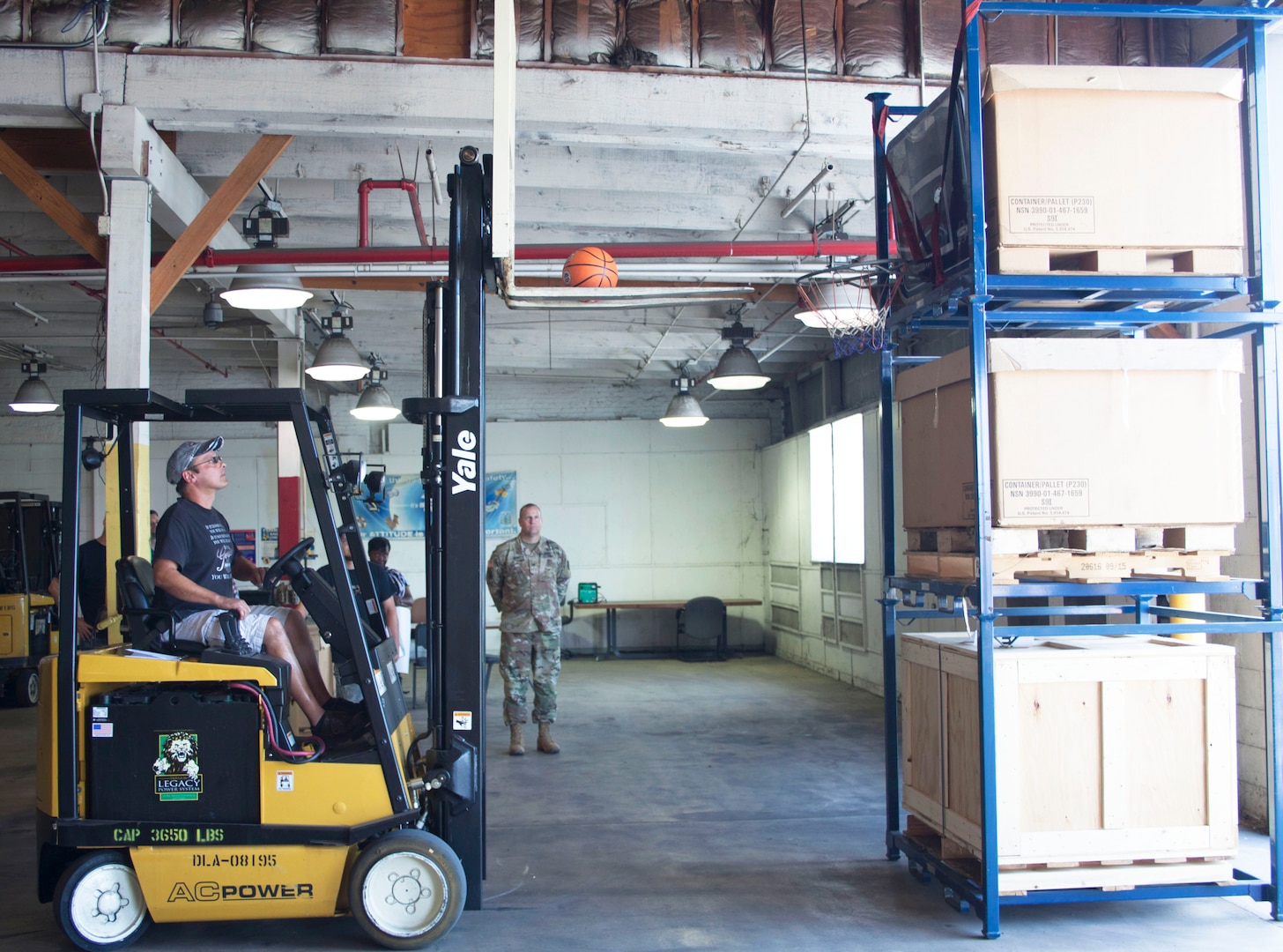 Daniel Ickes, DLA Distribution Susquehanna West Bulk employee puts the basketball through the hoop at the end of the obstacle course during the Susquehanna Forklift Rodeo on July 20.