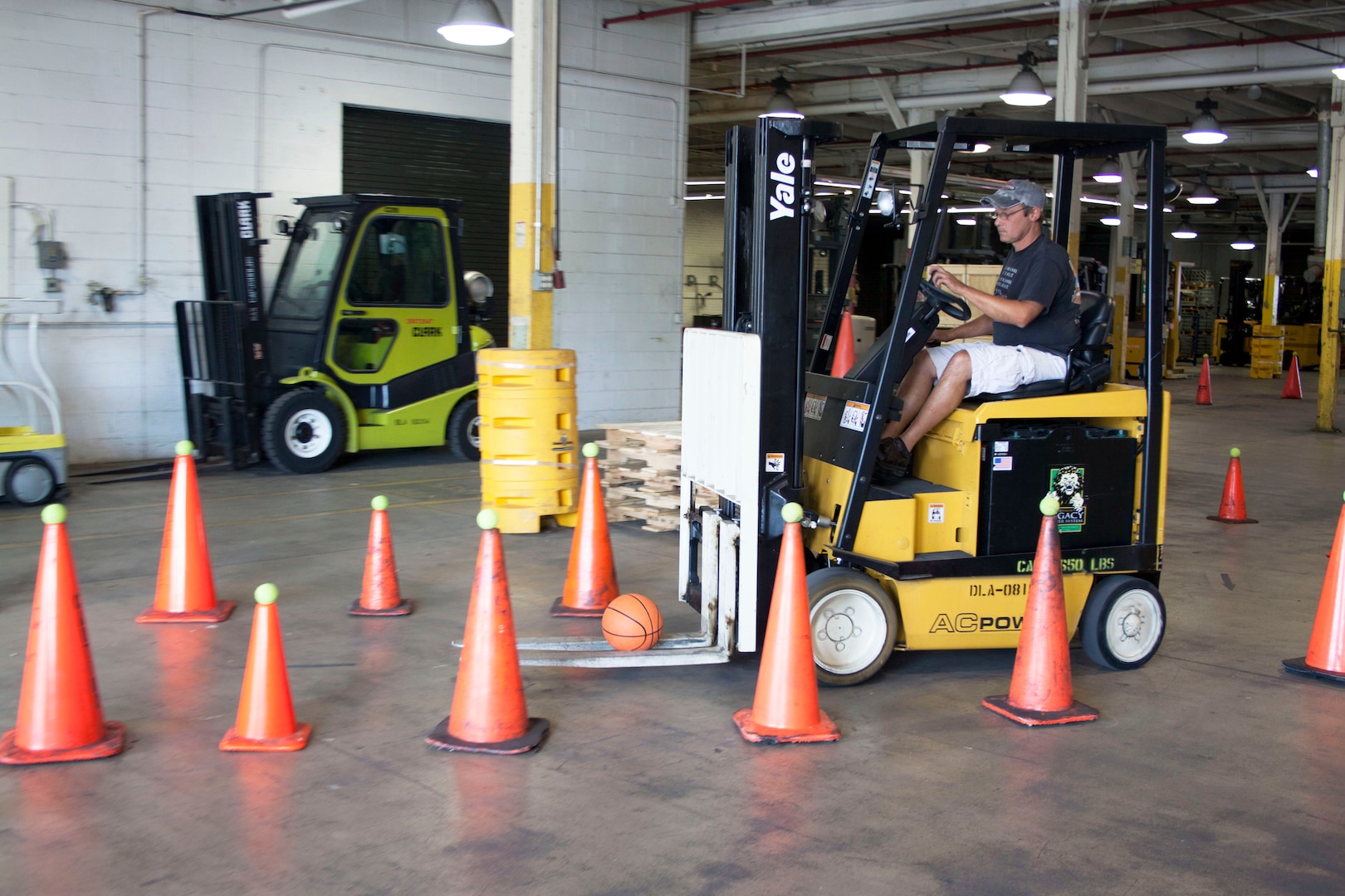 Daniel Ickes, DLA Distribution Susquehanna West Bulk employee maneuvers his forklift and basketball through a tight, windy section of cones during the Susquehanna Forklift Rodeo on July 20.