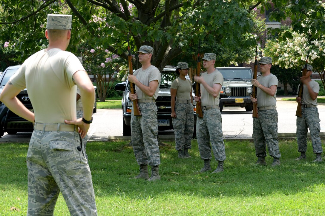 U.S. Air Force Staff Sgt. Christopher Spear, U.S. Air Force Honor Guard ceremonial guardsman, watches a firing party render military honors during a full service funeral demonstration at Langley Air Force Base, Va., July 26, 2016. Members of the USAFHG mobile training teams train and critique base-level Honor Guard Airmen for several days to ensure they are prepared to rendering full military honors at a burial service. (U.S. Air Force photo by Staff Sgt. Teresa J. Cleveland)