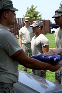 U.S. Air Force Airman 1st Class Dustin White, U.S. Air Force Honor Guard ceremonial guardsman, observes a team of pall bearers from the Langley Honor Guard as they practice a full service funeral sequence. USAHG members share personal stories from ceremonies they have participated in to help Airmen understand the importance of the honors they render. (U.S. Air Force photo by Staff Sgt. Teresa J. Cleveland)