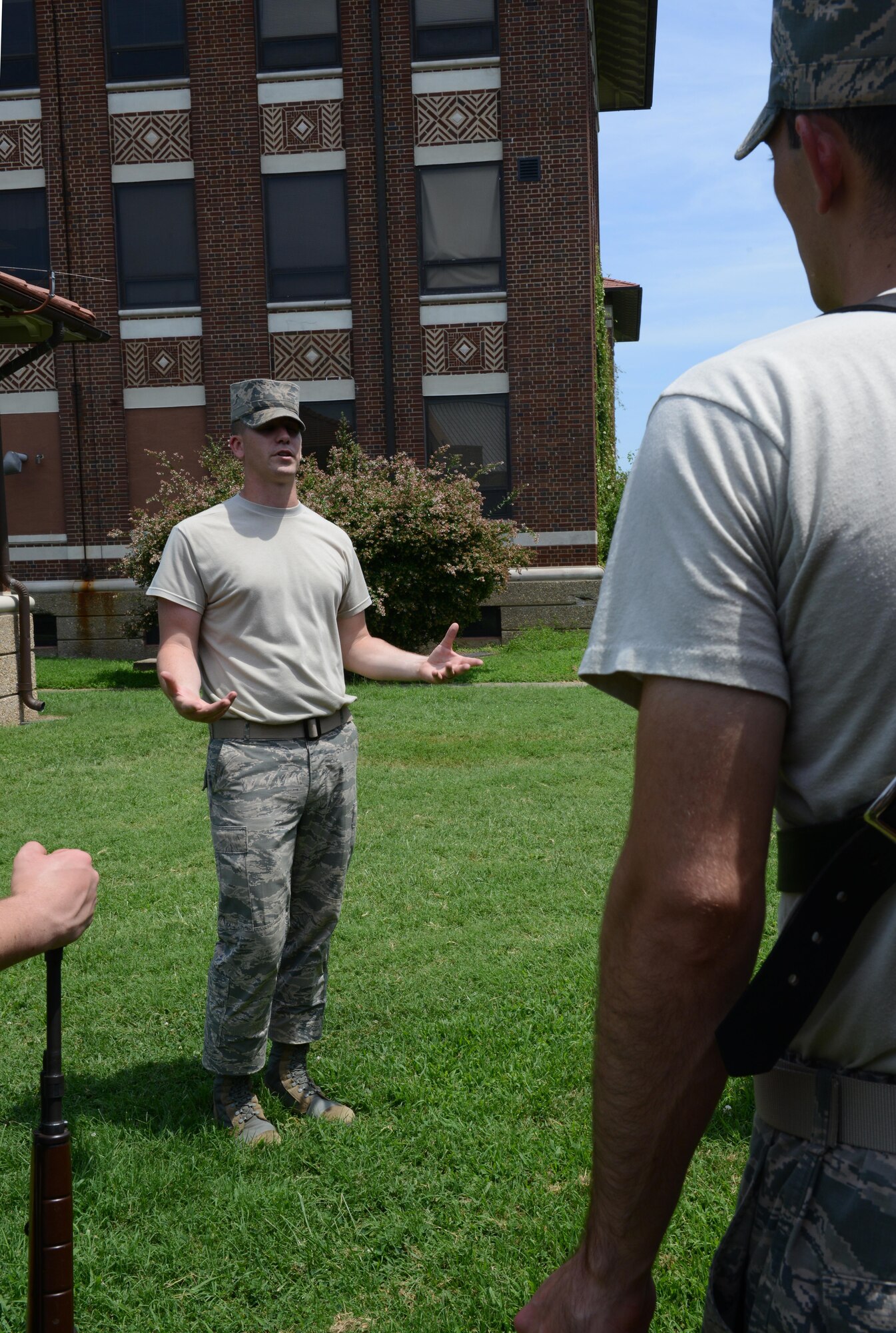 U.S. Air Force Airman 1st Class Dustin White, U.S. Air Force Honor Guard ceremonial guardsman, critiques a color guard team from the Langley Honor Guard at Langley Air Force Base, Va., July 26, 2016. At the end of the training period with the USAHG mobile training team, the Langley Honor Guard will perform one final full service funeral practice for their leadership to show they are prepared to render full military honors. (U.S. Air Force photo by Staff Sgt. Teresa J. Cleveland)