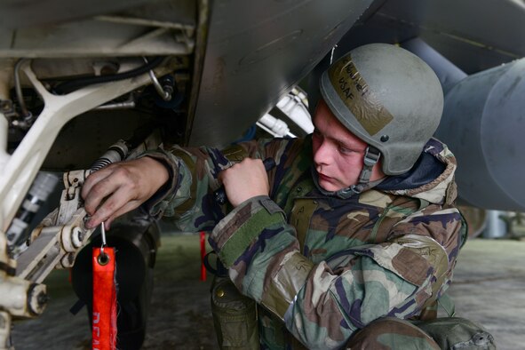 Airman 1st Class Nicholas Novosel, 8th Aircraft Maintenance Squadron crew chief, checks pins and moving parts on an F-16 Fighting Falcon during Beverly Pack 16-4 at Kunsan Air Base, Republic of Korea, July 25, 2016. The exercise tested Airmen on their ability to survive and operate while under the stress of simulated wartime activities. (U.S. Air Force photo by Senior Airman Ashley L. Gardner/Released)