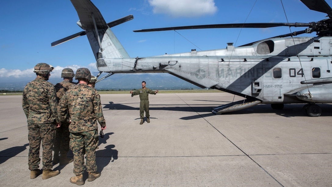 Staff Sgt. Derek Torrellas, a crew chief with Marine Heavy Helicopter Squadron 772, Special Purpose Marine Air-Ground Task Force - Southern Command, briefs Marines on the Humanitarian Assistance Survey Team on the proper way to board and disembark a CH-53E Super Stallion at Soto Cano Air Base, Honduras, July 22, 2016. The Marines and sailors used the exercise to maintain proficiency in quick response and proper execution in the event of a natural disaster.