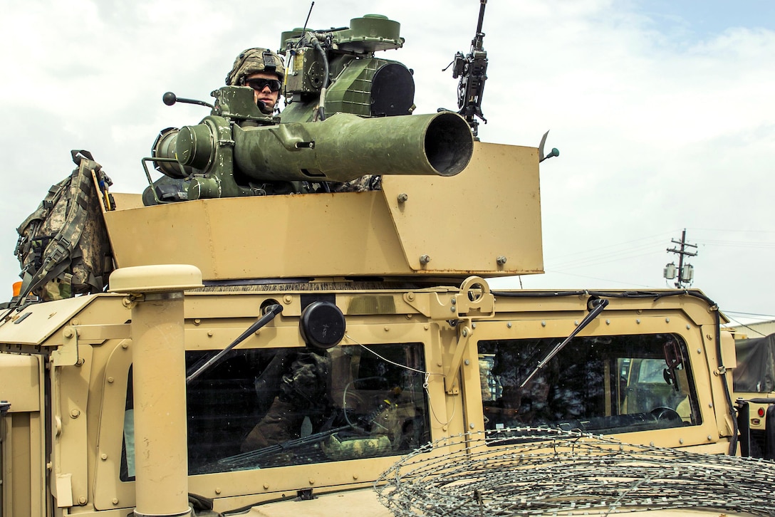 A soldier mans a Humvee's turret equipped with a Javelin anti-tank missile and an M240 machine gun as the unit stages a convoy at the Joint Readiness Training Center in Fort Polk, La., July 17, 2016. The soldier is assigned to the New York Army National Guard's Company B, 1st Battalion, 69th Infantry Regiment. About 5,000 soldiers, including those from the Guard, honed their skills and practiced integrating combat operations as part of the 27th Infantry Brigade Combat Team task force. Army National Guard photo by Sgt. Harley Jelis 