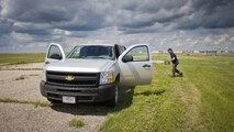 Dale Waites, U.S. Department of Agriculture wildlife biologist, removes a live trap from the airfield at Minot Air Force Base, N.D., July 15, 2016. Waites, a part of the Bird Airstrike Hazard program (BASH), set multiple traps for American kestrels, the most common falcon in North American. (U.S. Air Force photo/Airman 1st Class J.T. Armstrong)