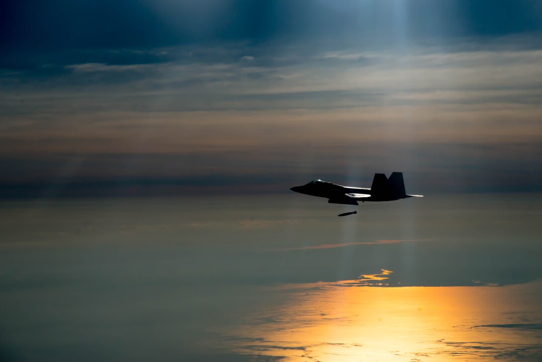 F-22A Raptor pilot assigned to the 94th Fighter Squadron drops a Joint Direct Attack Munitions during the 95th anniversary of Maj. Gen. William “Billy” Mitchell bombing the Ostfriesland at Langley Air Force Base, Va., July 21, 2016. Mitchell and the 1st Provisional Air Brigade demonstrated to the world the superiority of air power by sinking the famous, unsinkable, Ostfriesland, a captured German battleship. (U.S. Air Force photo by Staff Sgt. J.D. Strong II)