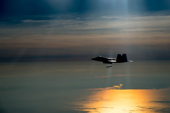 F-22A Raptor pilot assigned to the 94th Fighter Squadron drops a Joint Direct Attack Munitions during the 95th anniversary of Maj. Gen. William “Billy” Mitchell bombing the Ostfriesland at Langley Air Force Base, Va., July 21, 2016. Mitchell and the 1st Provisional Air Brigade demonstrated to the world the superiority of air power by sinking the famous, unsinkable, Ostfriesland, a captured German battleship. (U.S. Air Force photo by Staff Sgt. J.D. Strong II)