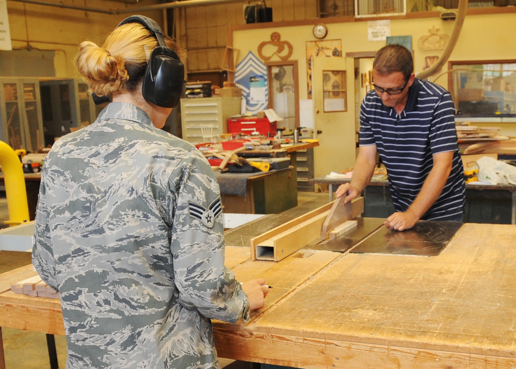 Tommy Brooks, 2nd Force Support Squadron community services flight chief, cuts pieces of wood to make a cutting board at Barksdale Air Force Base, La., July 19, 2016. The wood shop makes and sells unique keepsakes, shadow boxes and recognition boards. (U.S. Air Force photo/Airman Alexis C. Frost)