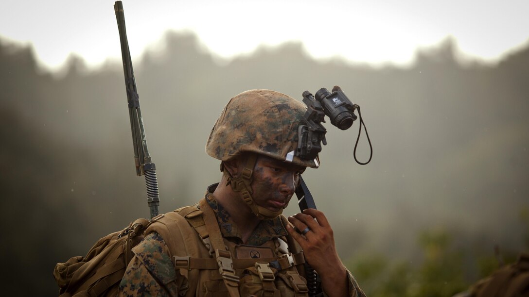 U.S. Marine Corps Cpl. Christopher Griffith a squad leader with Lima Company, 3rd Battalion, 4th Marine Regiment, conducts a radio check during the Advanced Infantry Course at Kahuku Training Area, Hawaii, July 18, 2016. AIC is intermediate training designed to enhance and test the Marine's skills and leadership abilities as squad leaders in a rifle platoon.