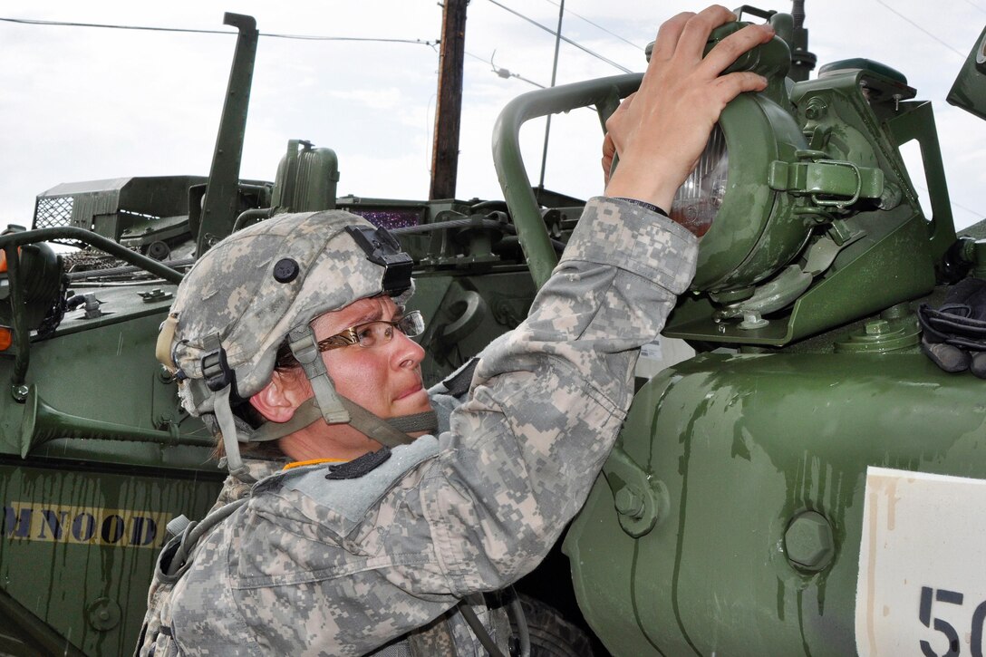 Army Staff Sgt. Leslie Schneider checks a headlight on an M1126 Stryker combat vehicle before moving it into the training area at the Joint Readiness Training Center in Fort Polk, La., July 17, 2016. Schneider is a mechanic assigned to the Pennsylvania Army National Guard’s Company A, 1st Battalion, 112th Stryker Brigade Combat Team. Army National Guard photo by Sgt. Maj. Corine Lombardo