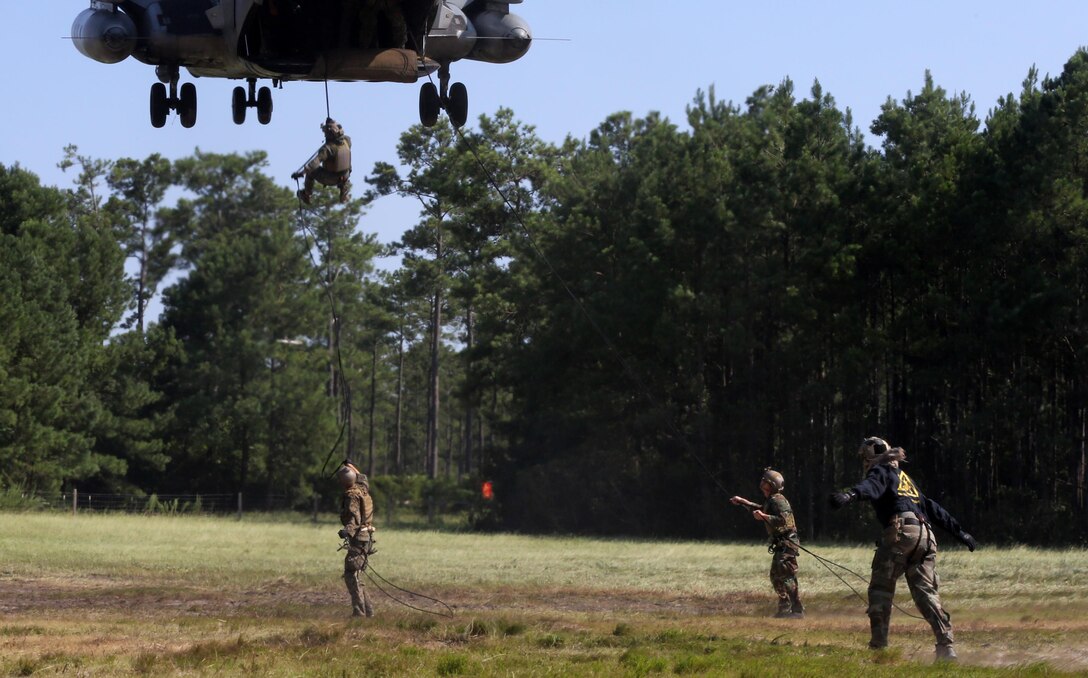 Marines with U.S. Marine Corps Forces Special Operations Command conduct a fast rope and rappelling course on Landing Zone Parrot at Marine Corps Base Camp Lejeune, N.C., July 20, 2016. The exercise was part of a two weeklong Helicopter Insertion and Extraction Techniques Course. The CH-53 provided for the training evolution was assigned to Marine Heavy Helicopter Squadron 461, 2nd Marine Aircraft Wing. (U.S. Marine Corps photo by Lance Cpl. Mackenzie Gibson/Released)