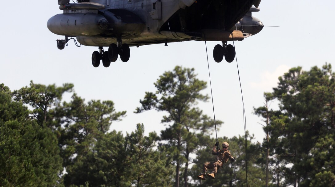 A Marine with U.S. Marine Corps Forces Special Operations Command rappels off the ramp of a CH-53E Super Stallion with Marine Heavy Helicopter Squadron 461 on Landing Zone Parrot at Marine Corps Base Camp Lejeune, N.C., July 20, 2016. The exercise was a part of a two weeklong Helicopter Insertion and Extraction Techniques Course. The CH-53 provided for the training evolution was assigned to Marine Heavy Helicopter Squadron 461, 2nd Marine Aircraft Wing. (U.S. Marine Corps photo by Lance Cpl. Mackenzie Gibson/Released)