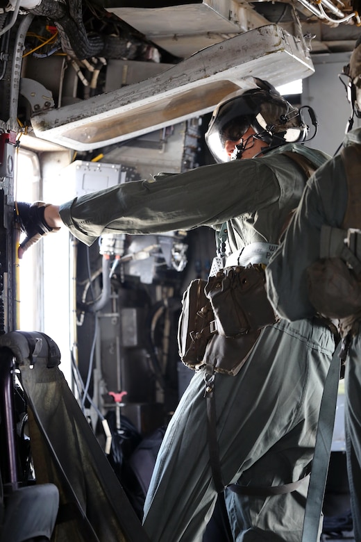 A Marine with Marine Heavy Helicopter Squadron 461 prepares to assist Marines with U.S. Marine Corps Forces Special Operations Command during a fast rope and rappelling training exercise on Landing Zone Parrot at Marine Corps Base Camp Lejeune, N.C., July 20, 2016. The exercise was a part of a two weeklong Helicopter Insertion and Extraction Techniques Course. The CH-53 provided for the training evolution was assigned to Marine Heavy Helicopter Squadron 461, 2nd Marine Aircraft Wing. (U.S. Marine Corps photo by Lance Cpl. Mackenzie Gibson/Released)