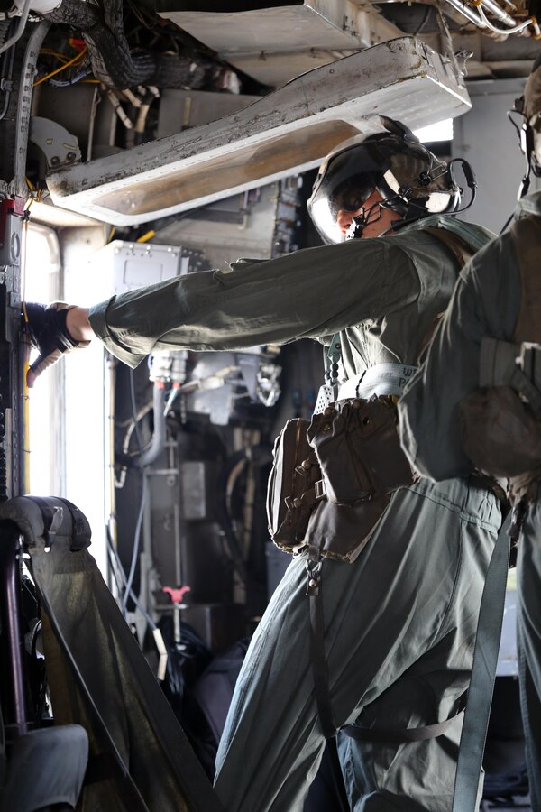 A Marine with Marine Heavy Helicopter Squadron 461 prepares to assist Marines with U.S. Marine Corps Forces Special Operations Command during a fast rope and rappelling training exercise on Landing Zone Parrot at Marine Corps Base Camp Lejeune, N.C., July 20, 2016. The exercise was a part of a two weeklong Helicopter Insertion and Extraction Techniques Course. The CH-53 provided for the training evolution was assigned to Marine Heavy Helicopter Squadron 461, 2nd Marine Aircraft Wing. (U.S. Marine Corps photo by Lance Cpl. Mackenzie Gibson/Released)