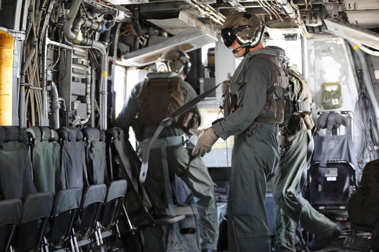 Marines with Marine Heavy Helicopter Squadron 461 prepare to assist Marines with U.S. Marine Corps Forces Special Operations Command during a fast rope and rappelling training exercise on Landing Zone Parrot at Marine Corps Base Camp Lejeune, N.C., July 20, 2016. The exercise was a part of a two weeklong Helicopter Insertion and Extraction Techniques Course. The CH-53 provided for the training evolution was assigned to Marine Heavy Helicopter Squadron 461, 2nd Marine Aircraft Wing. (U.S. Marine Corps photo by Lance Cpl. Mackenzie Gibson/Released)