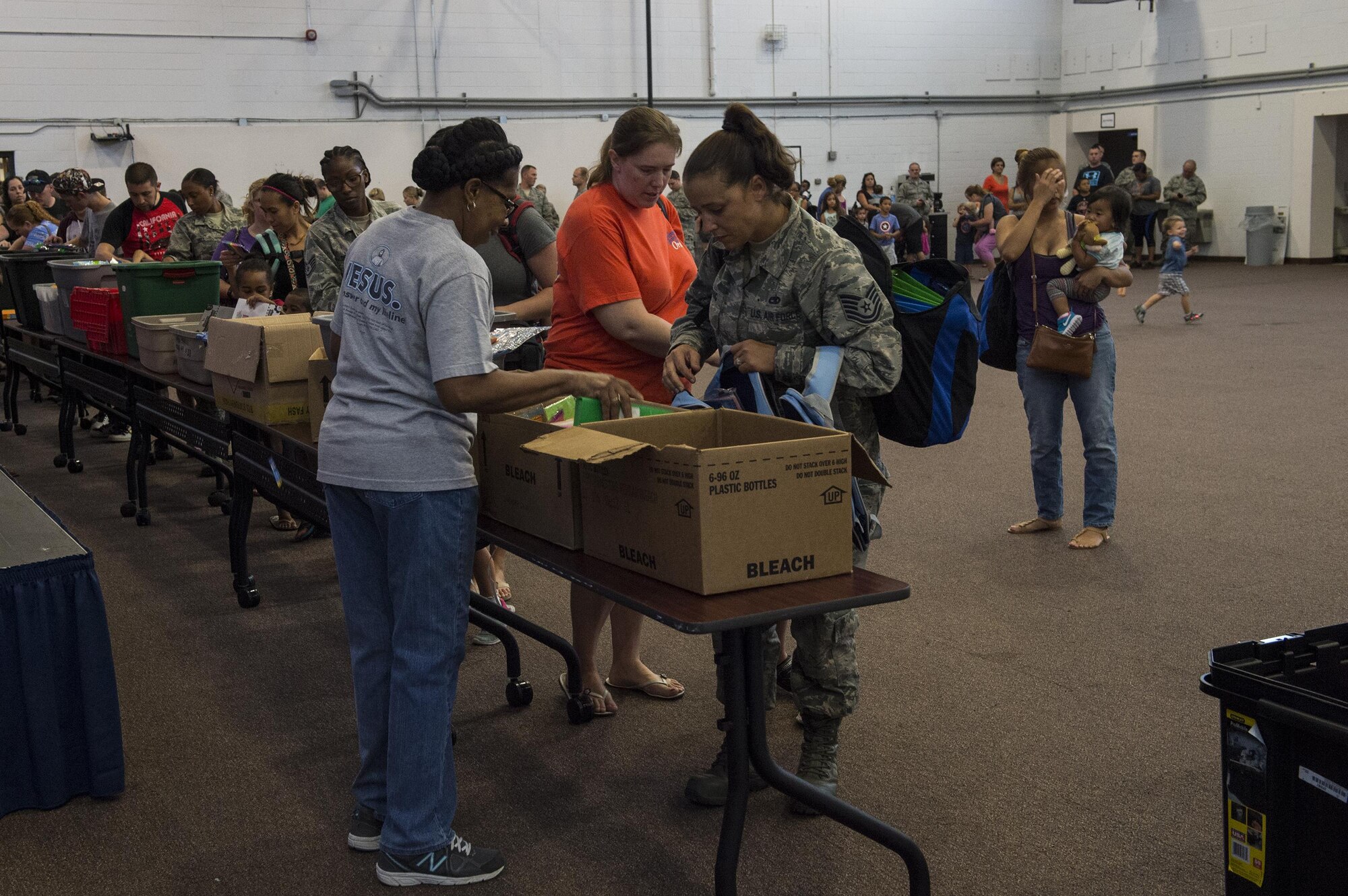 Attendees select school supplies during the Back to School Brigade, July 27, 2016, at Moody Air Force Base, Ga. The local community provided paper, pencils, notebooks, crayons, folders and a variety of other school supplies for children to use during the upcoming school year. (U.S. Air Force photo by Airman 1st Class Janiqua P. Robinson)