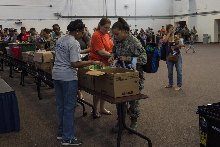 Attendees select school supplies during the Back to School Brigade, July 27, 2016, at Moody Air Force Base, Ga. The local community provided paper, pencils, notebooks, crayons, folders and a variety of other school supplies for children to use during the upcoming school year. (U.S. Air Force photo by Airman 1st Class Janiqua P. Robinson)